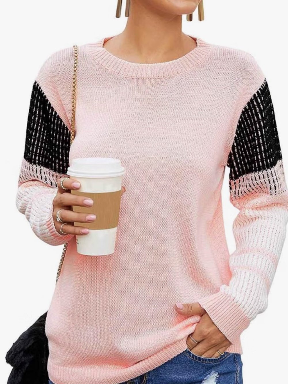 Soft pink knit sweater with contrasting black and white colorblock sleeves. Rela